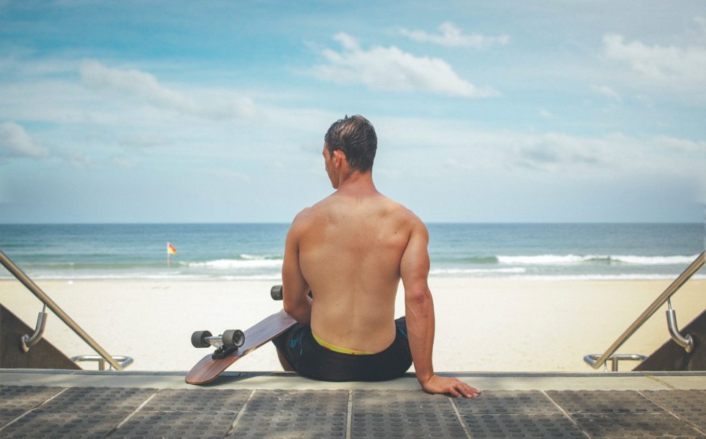 A man skateboarding because he got relief with acupuncture for lower back pain.